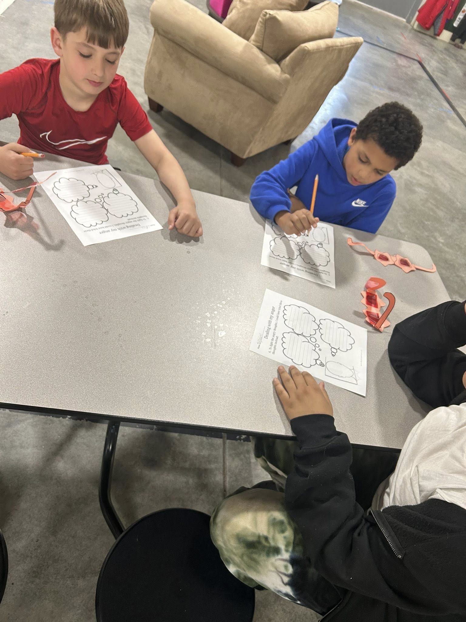 Children receiving homework help at Atchison After School Club